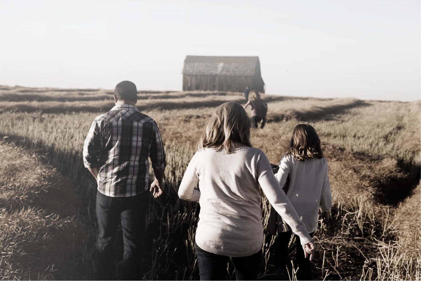 Family walking through farm field